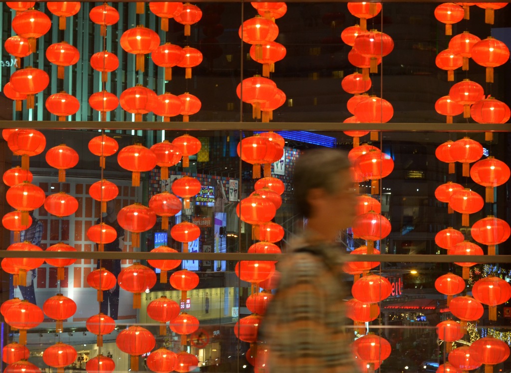 A man walk pass by  Chinese New Year decoration in Kuala Lumpur shopping mall . January 31 , 2014