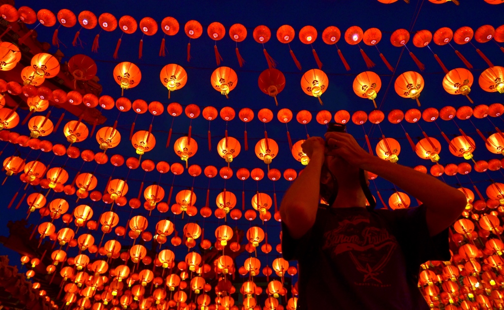 A tourist taking a picture of lantern decoration at  Thean Hou Temple on the  Chinese Lunar New Year of the horse in Kuala Lumpur on January 31 , 2014
